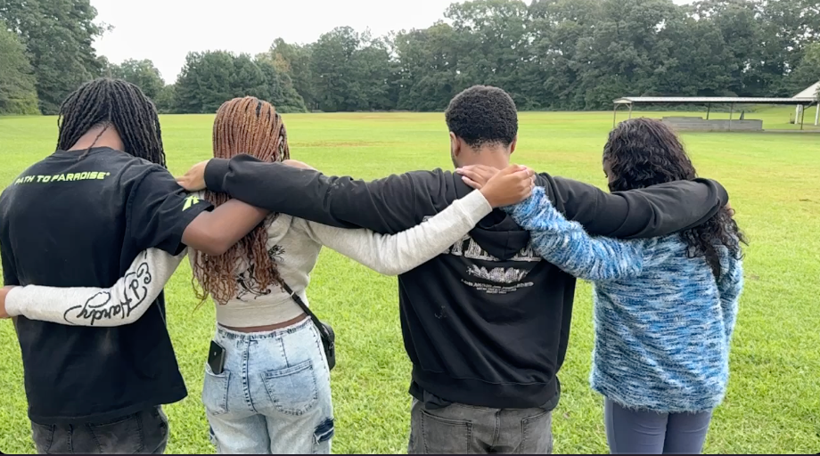 Illumin8 students worshipping on stage during a youth service